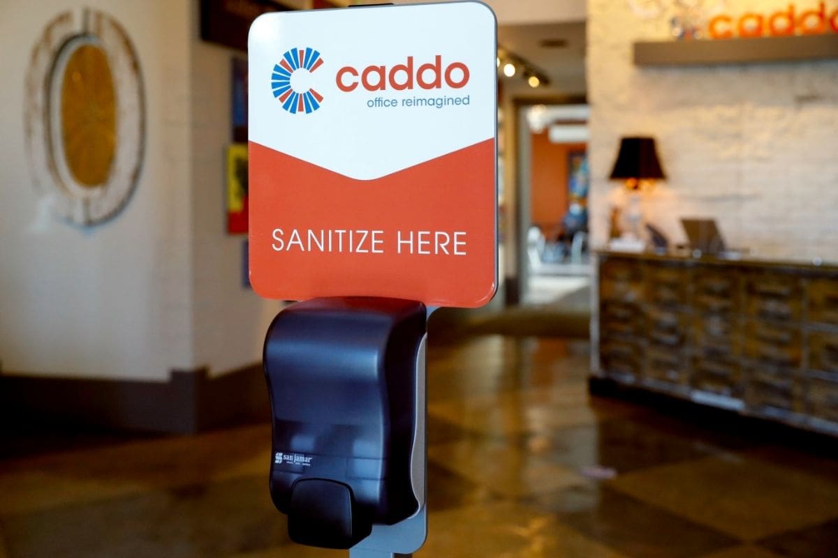 Hand sanitizer station in the coworking space at Caddo Office Reimagined